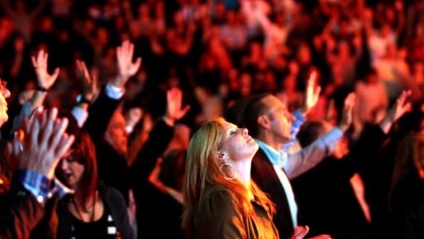 A worshipper at the Hillsong Conference, 2008 ... the Church has called in lawyers after satirical lyrics took aim at it.