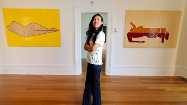 Yeojin Bae at Linden New Art Gallery in St Kilda, in front of two works from Stephanie Leigh's Feminine Flatpack series.