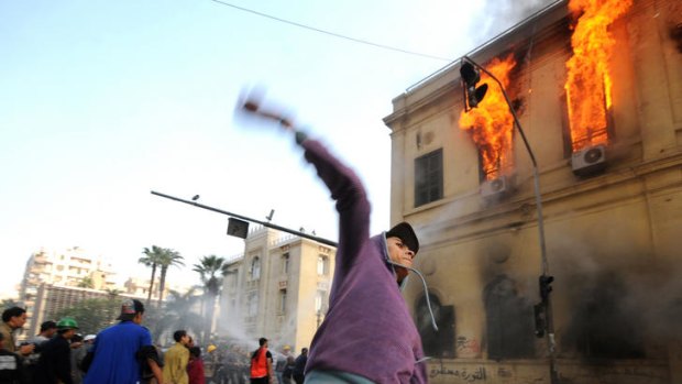 Protester throws stones at Egyptian miltary police in Tahrir Square, Cairo.