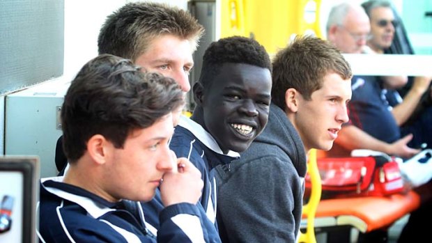 Happy: Gach Nyuon with his Victoria Country teammates.