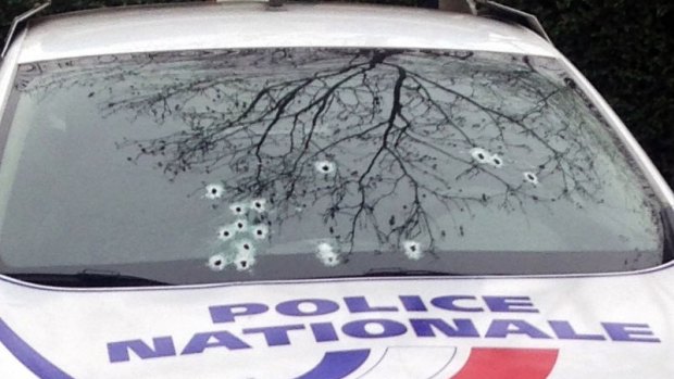 A police car is riddled with bullets during an attack on the offices of the newspaper Charlie Hebdo.