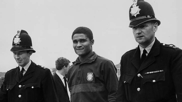 Eusebio being escorted by two policemen at the 1966 World Cup to protect him from autograph hunters.