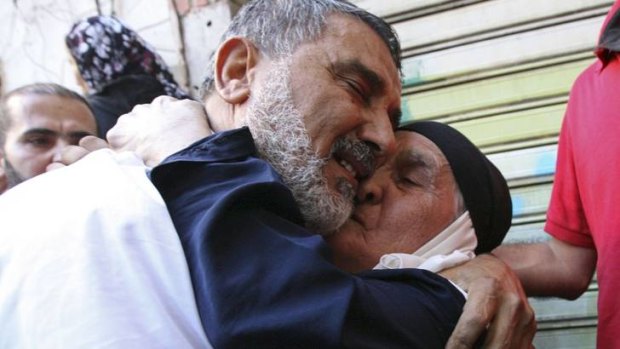Hussein Omar hugs his mother.