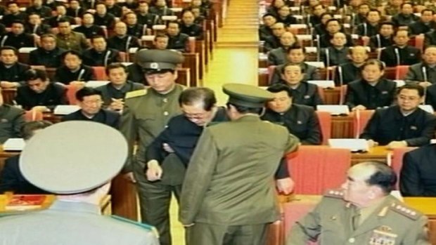 Jang Song-Thaek is dragged out of his chair during a meeting in Pyongyang.