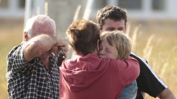 Loved ones at the scene react to the news.
