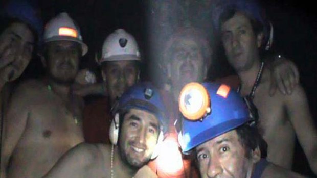 Trapped Chilean miners pose inside the mine.