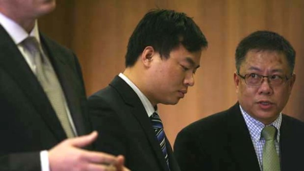 Haisong Jiang, center, appears in Newark Municipal Court with his attorney and an interpreter on a charge of defiant trespassing.
