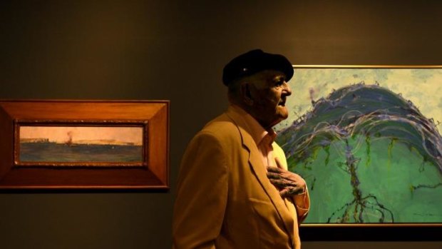 Australian artist John Olsen with <i>Sydney Harbour</i> by Arthur Streeton (left), which inspired his new work <i>The Rolling Sea-and That Streeton Painting</i> (right).