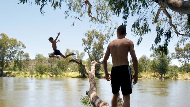 Joe Muntz takes full advantage of the year's high water flows, jumping into the river at Albury-Wodonga.