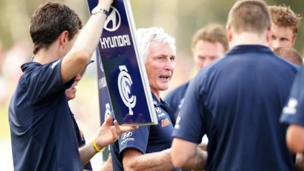 Blues coach Mick Malthouse speaks to his players.