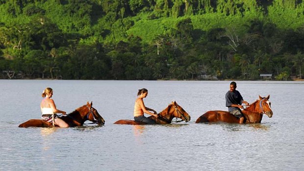 Cooling off ... horse riding at Port Vila.