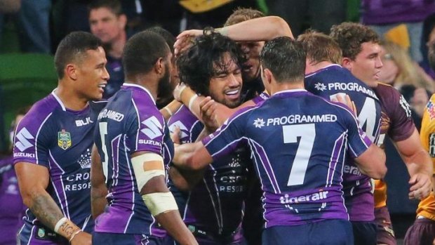 Mahe word: Melbourne players celebrate with Mahe Fonua after his intercept try sealed victory for the Storm. 