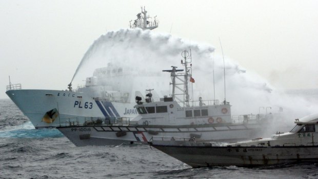 A Japanese Coast Guard patrol boat sprays a water cannon over a Taiwan Coast Guard boat to warn a Taiwanese leisure boat carrying four Taiwanese activists that they not to go any further towards the disputed Senkaku/Diaoyu Islands in East China Sea.