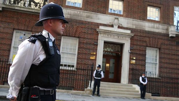 A royal appointment: Police guard the Lindo Wing of St Mary's Hospital after the Duchess of Cambridge went into labour.