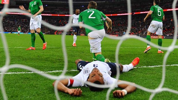 Ashley Cole of England lies prone after another missed chance.