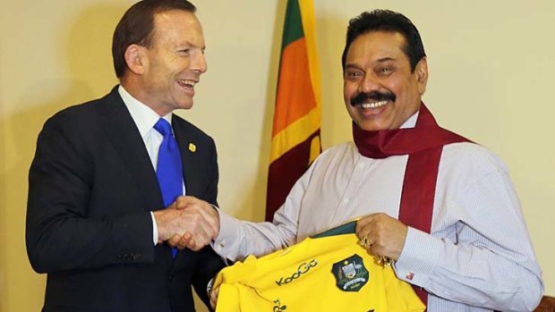 The company we keep: Australia's Prime Minister Tony Abbott  shakes hands with Sri Lanka's President Mahinda Rajapaksa.