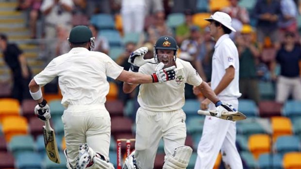 Milestone moment ...  Mike Hussey, centre, celebrates his century with batting partner Brad Haddin during the third day of the first Test in which Australia took an iron grip on proceedings.