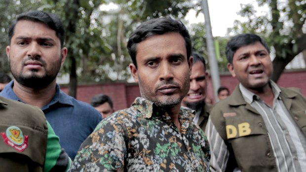 Bangladeshi police escort Shariful Islam after his arrest on Sunday. 