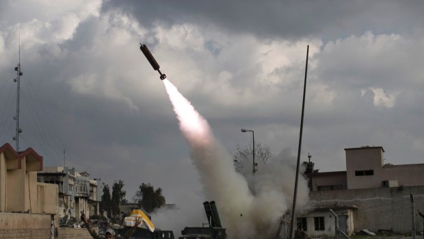 Federal Police Rapid Response Forces fire a rocket towards Islamic State positions near the old city in Mosul.