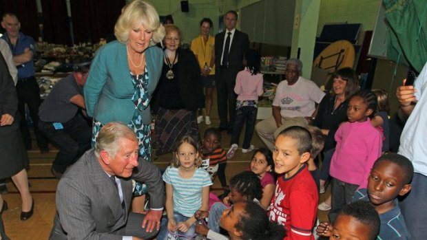 The Prince of Wales and his wife Camilla chat to children during a visit to the Tottenham Green Leisure Centre in north London.