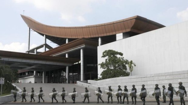 Thai soldiers form a cordon outside Bangkok's Army Club, where talks between Thailand's rival factions are taking place under the aegis of the military.