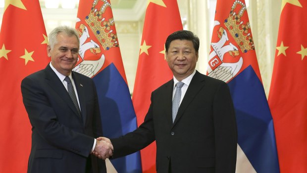 Serbian President Tomislav Nikolic, left, poses with Chinese President Xi Jinping in the Great Hall of the People in Beijing. 