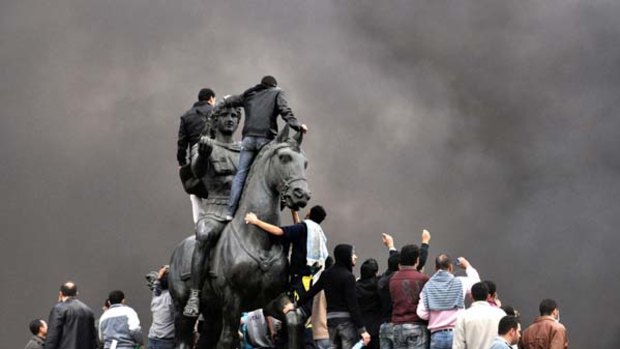 Angry scenes ... protesters gather at the statue of Alexander the Great in Cairo to demand the resignation of Hosni Mubarak