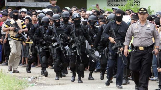Members of the anti-terror police arrive at the village of Batu Rengat.