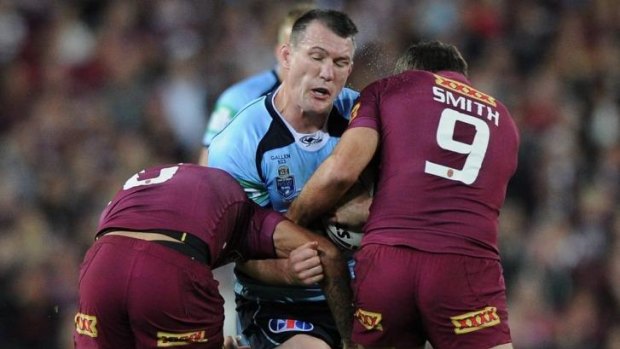 Captain courageous: Paul Gallen hits the ball up into the teeth of the Queensland defence.