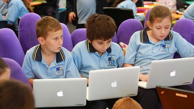 Noisier but not distracting . . . Zac Gerheard (from left), Christian Stathopoulos and Bessie Phillips work on their laptops in the mega classroom at St Monica's Primary.