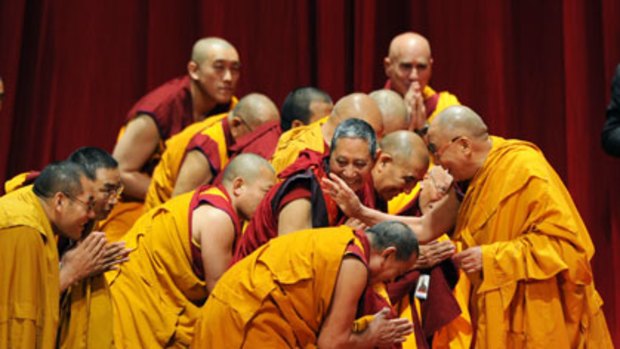 Many happy returns... the Dalai Lama greets monks on stage at Radio City Music Hall on Thursday during the first of six teaching sessions he will hold in New York.