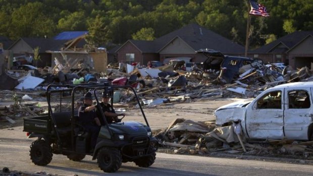 Police officers enforce a curfew after a tornado hit Vilonia, Arkansas on a second day of storms.