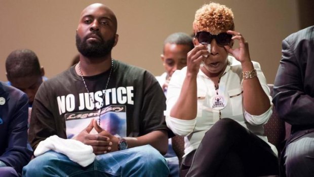 Lesley McSpadden (right) and Michael Brown Sr. (left), parents of 18-year-old Michael Brown, listen to speakers during a rally convened in reaction to the shooting of their son, in Ferguson, Missouri.