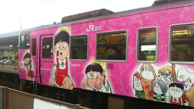 A train emblazoned in manga characters.