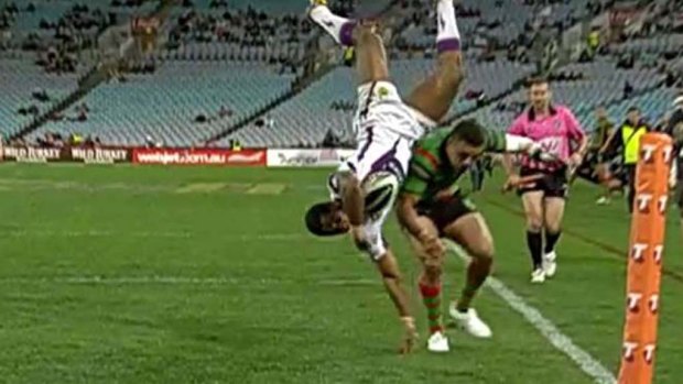 Melbourne's Sisa Waqa falls awkwardly after contact with Dylan Farrell.