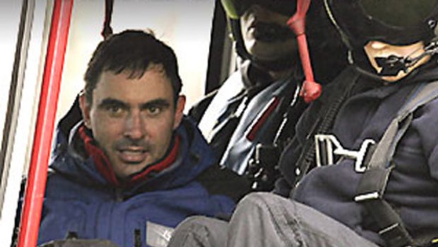 Found alive ... Victorian minister Tim Holding in a rescue helicopter.