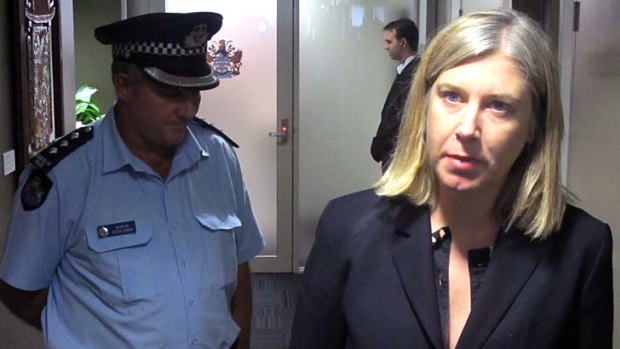 Cr Nicole Johnston being escorted by police from the Brisbane City Council chambers.