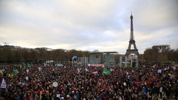 Activists gather near the Eiffel Tower.