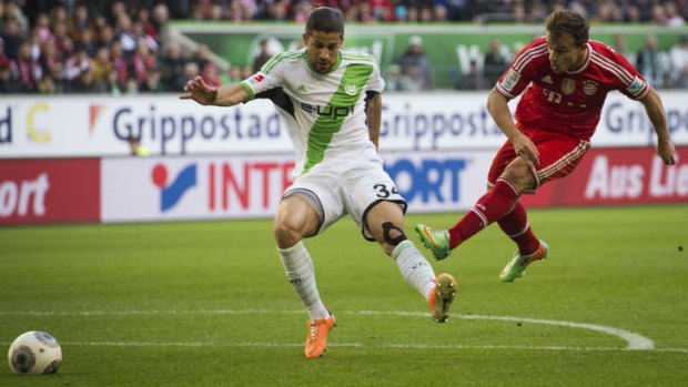 Bayern Munich's midfielder Xherdan Shaqiri swoops on the ball ahead of  Wolfsburg's defender Ricardo Rodriguez.