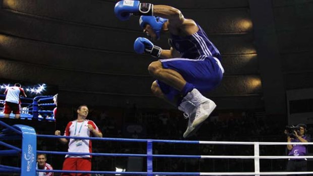 Anthony Ogogo of England jumps up and down as he jeers the crowd after winning against Vijender Singh of India.