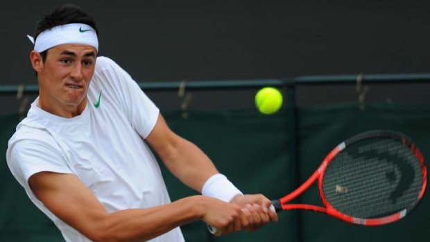Win and Tomic ... Bernard Tomic hits a return to Igor Andreev of  Russia. The Australian great, John Newcombe, says Tomic has the potential to make the top 50.