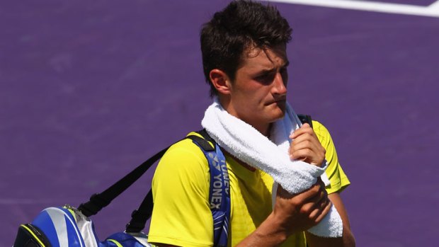 Frustrated  ... Tomic leaves the court after his defeat.