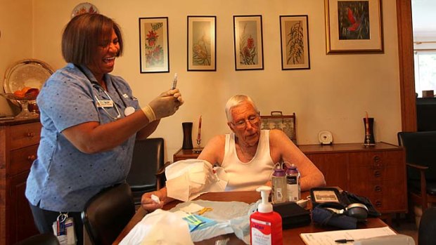 Home support ... nurse Cynthia Holbeck attends to patient Don Auchterloni in his home.