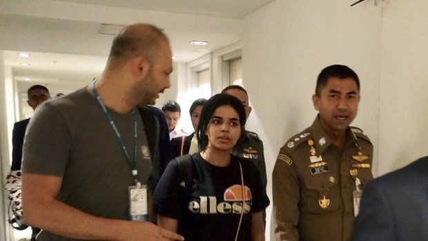 Chief of Immigration Police, Major General Surachate Hakparn (right) walks with Rahaf Mohammed al-Qunun as she leaves Suvarnabhumi Airport in Bangkok  last month. 