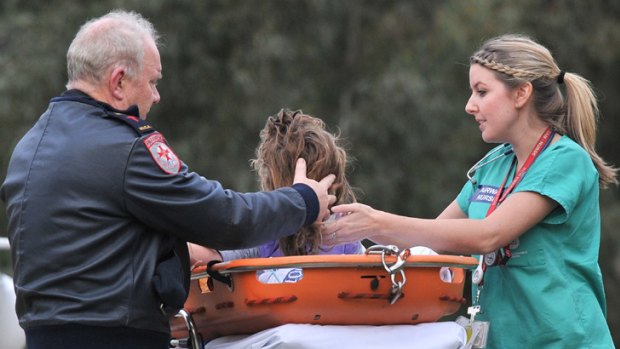 An injured child is taken to the Royal Children's Hospital after a car crash on the Goulburn Valley Highway at Molesworth, near Yea.