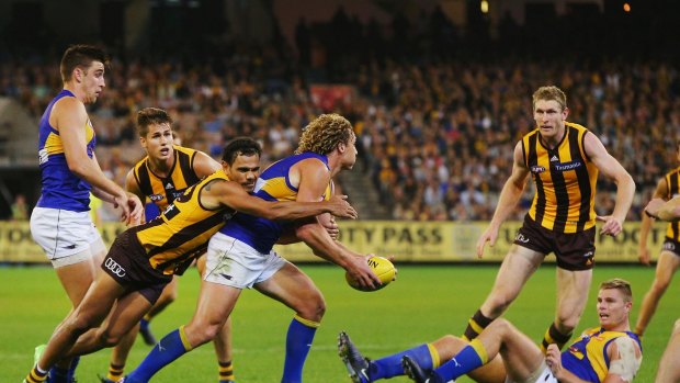Sizzling: Cyril Rioli's influence wasn't seen in the stats, here tackling West Coast's Matt Priddis.