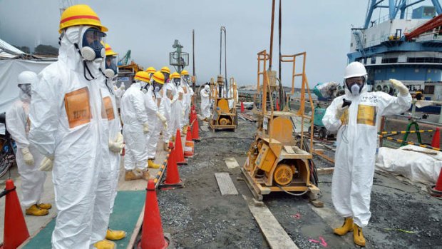 Local government officials and nuclear experts inspect attempts to prevent the seepage of contaminated water into the sea earlier this month.