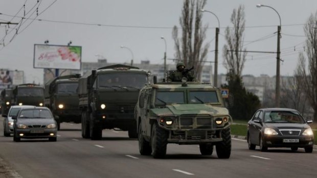 The troop convoy moves through the  streets of Simferopol.