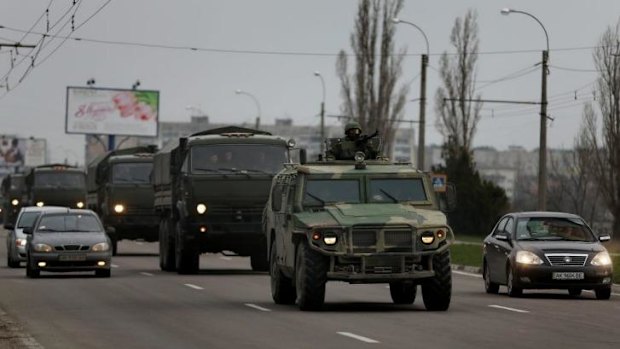 The troop convoy moves through the  streets of Simferopol.