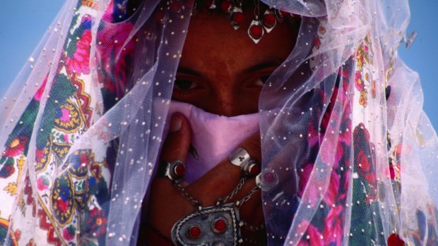 A bride wears  traditional Turkmen headwear and jewellery,